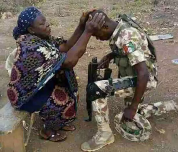 Check Out This Heartwarming Photo Of A Nigerian Mum Praying For Her Son, A Soldier… As He Goes To Fight Boko Haram In The Northeast